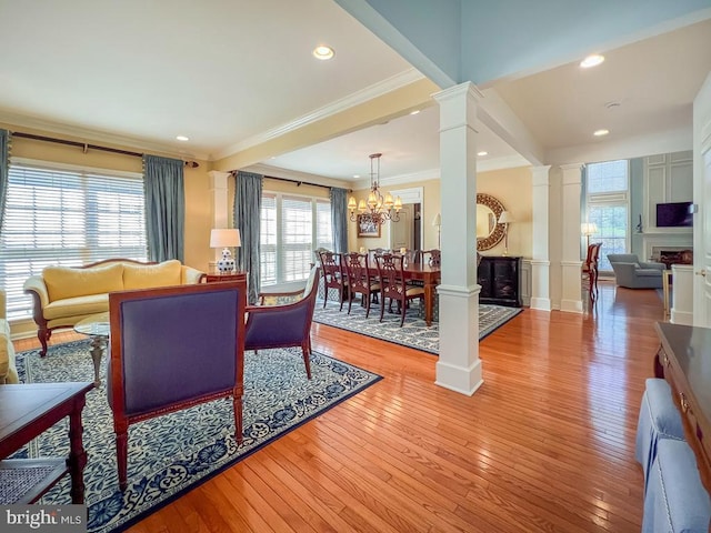 11 Mcconkey Dr, Washington Crossing, PA 18977 - living area featuring a fireplace, ornamental molding, light wood-style flooring, and decorative columns