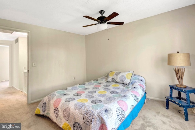 bedroom with baseboards, ceiling fan, carpet, and visible vents