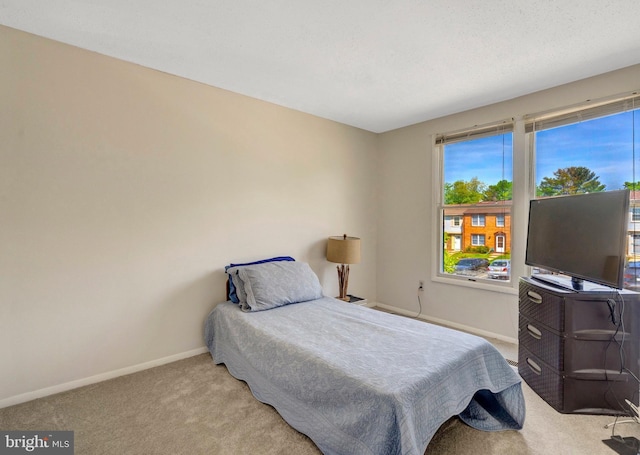 carpeted bedroom featuring baseboards