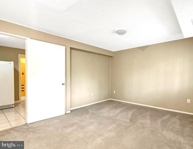 spare room featuring baseboards and carpet