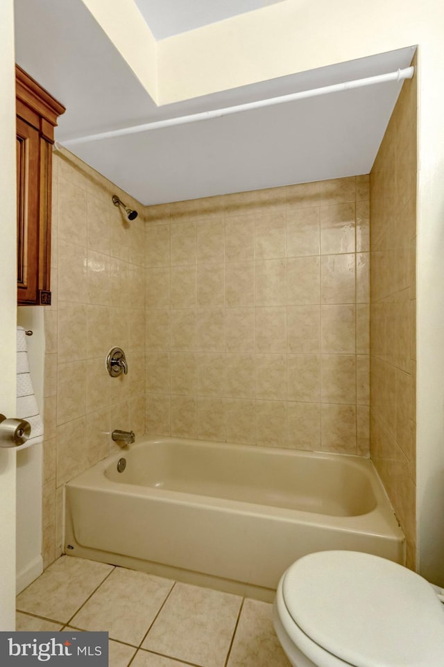 bathroom with tile patterned flooring, shower / bathing tub combination, and toilet