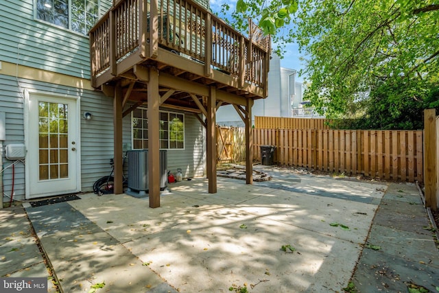 view of patio / terrace with central AC, a wooden deck, and a fenced backyard