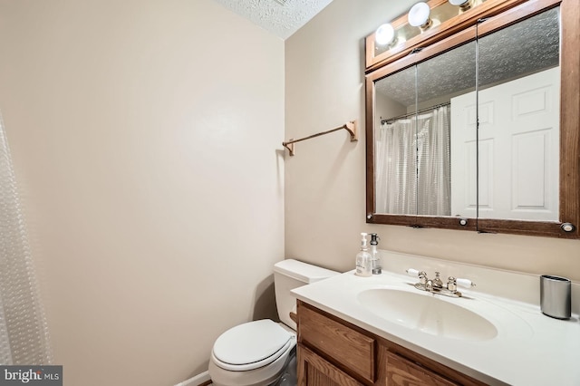 1317 Greenbriar Cir Unit 7-1317, Pikesville, MD 21208 - bathroom featuring toilet, vanity, a textured ceiling, and curtained shower