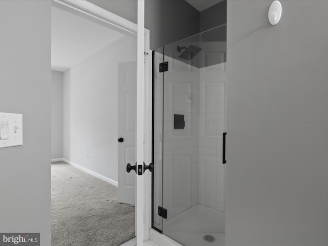 full bathroom with baseboards and a stall shower
