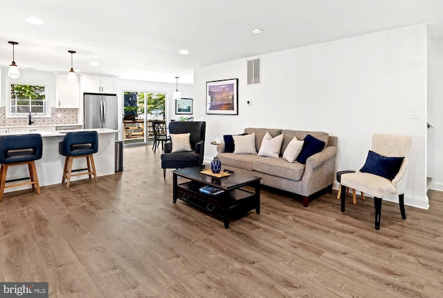 327 Oakwood St, Bethany Beach, DE 19930 - living area featuring light wood-type flooring, recessed lighting, healthy amount of natural light, and baseboards