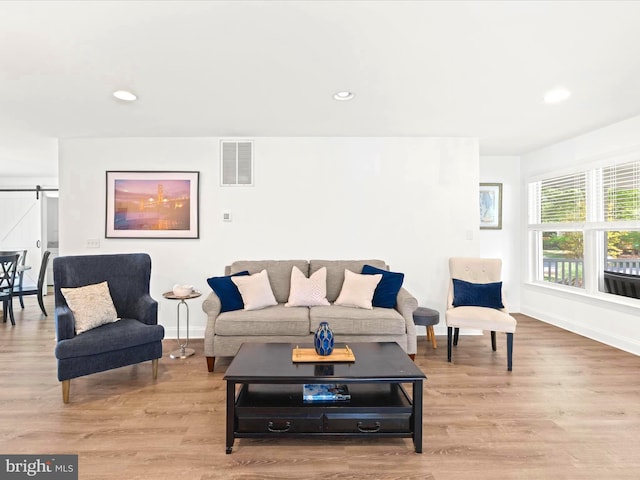 327 Oakwood St, Bethany Beach, DE 19930 - living room with baseboards, a barn door, light wood-type flooring, and recessed lighting