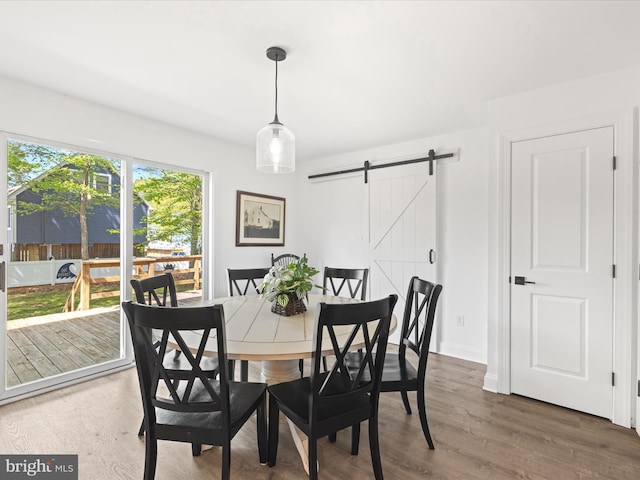 327 Oakwood St, Bethany Beach, DE 19930 - dining area with a barn door, wood finished floors, and baseboards