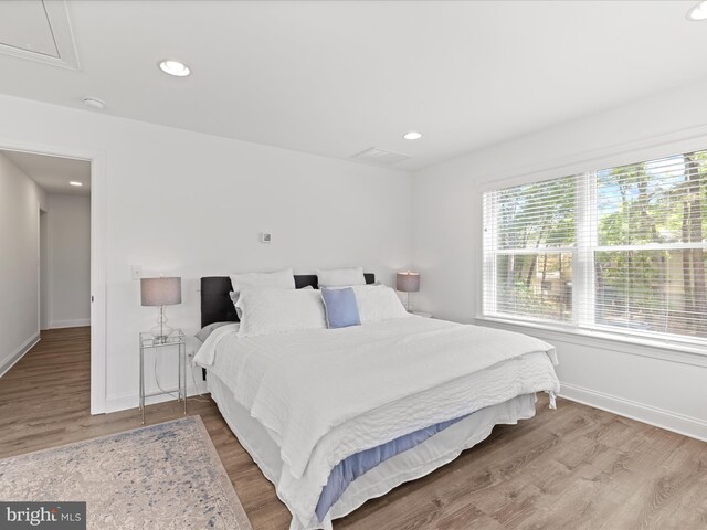 327 Oakwood St, Bethany Beach, DE 19930 - bedroom featuring multiple windows, baseboards, wood finished floors, and recessed lighting