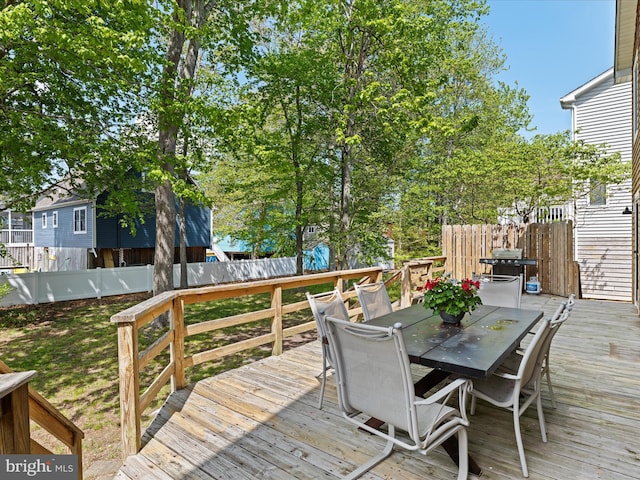 327 Oakwood St, Bethany Beach, DE 19930 - wooden deck featuring outdoor dining area and a fenced backyard