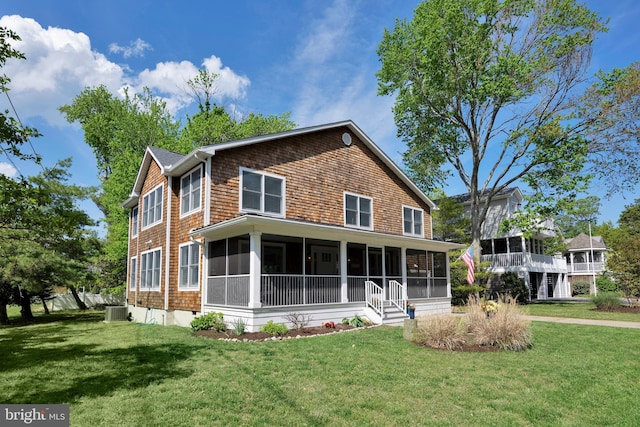 327 Oakwood St, Bethany Beach, DE 19930 - view of front facade with a sunroom, a front lawn, and cooling unit