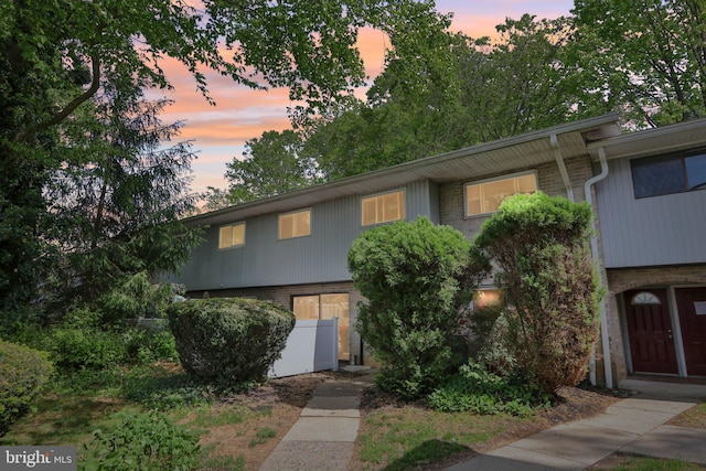 townhome / multi-family property featuring brick siding