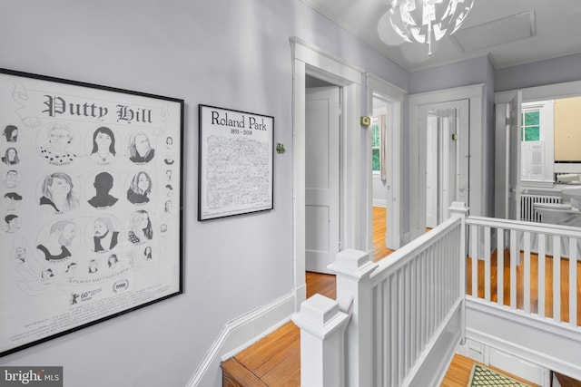 detailed view of wood finished floors, radiator heating unit, and ornamental molding