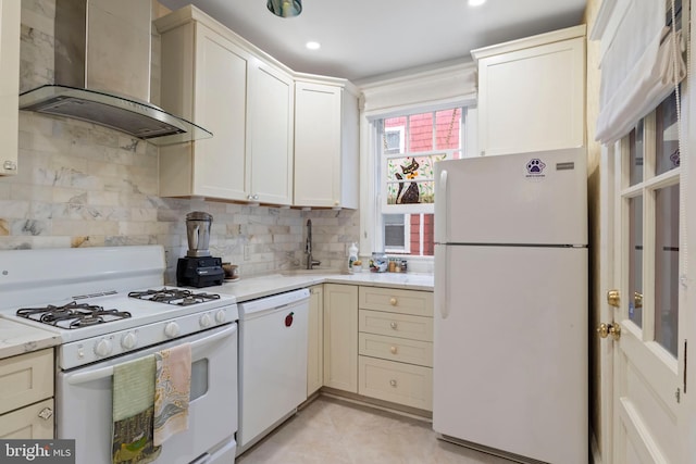 kitchen with white appliances, wall chimney range hood, a sink, decorative backsplash, and light tile patterned floors