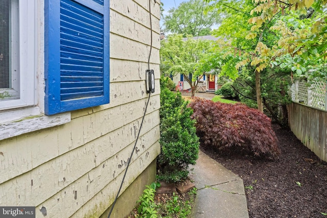 view of side of home featuring fence