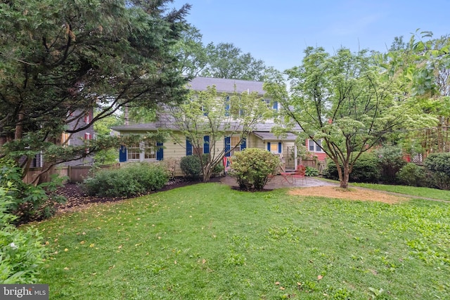 view of front of house featuring a patio area and roof with shingles