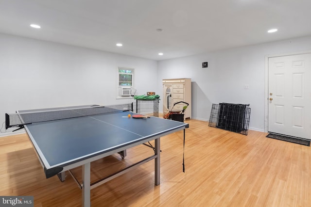 recreation room with light wood-style floors, recessed lighting, baseboards, and cooling unit