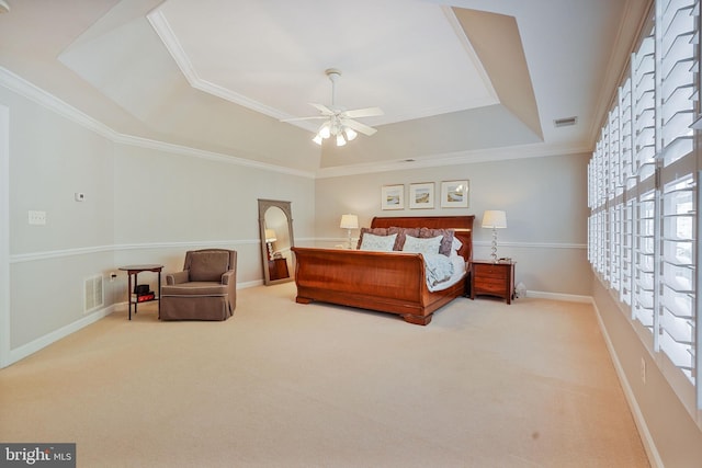 bedroom featuring a raised ceiling, multiple windows, carpet, and visible vents