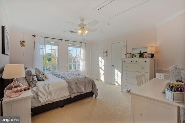 bedroom featuring two closets, light colored carpet, ornamental molding, and attic access