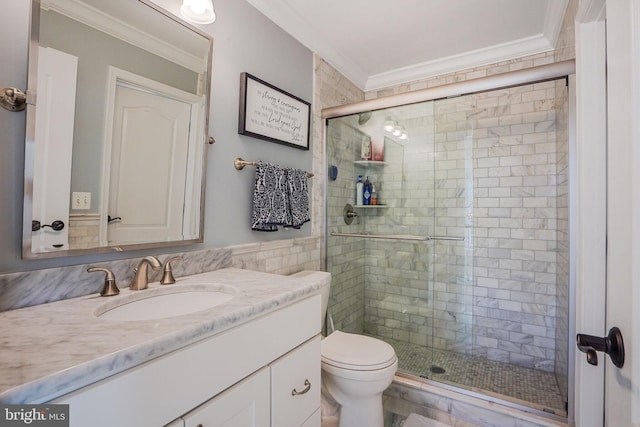full bathroom with vanity, ornamental molding, a shower stall, and toilet