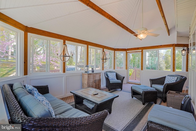 living area featuring ceiling fan and lofted ceiling