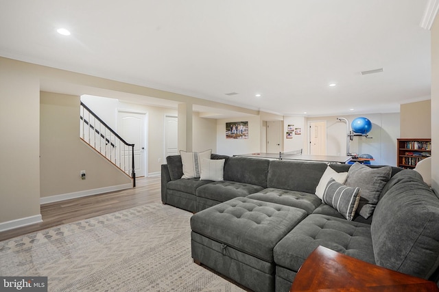 living area featuring recessed lighting, baseboards, stairs, and wood finished floors