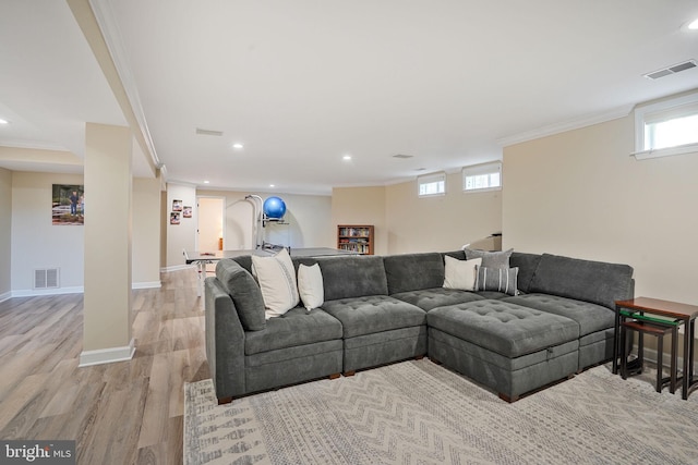 living room featuring recessed lighting, ornamental molding, light wood finished floors, and visible vents