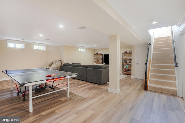 recreation room featuring recessed lighting, baseboards, ornamental molding, and light wood-style floors