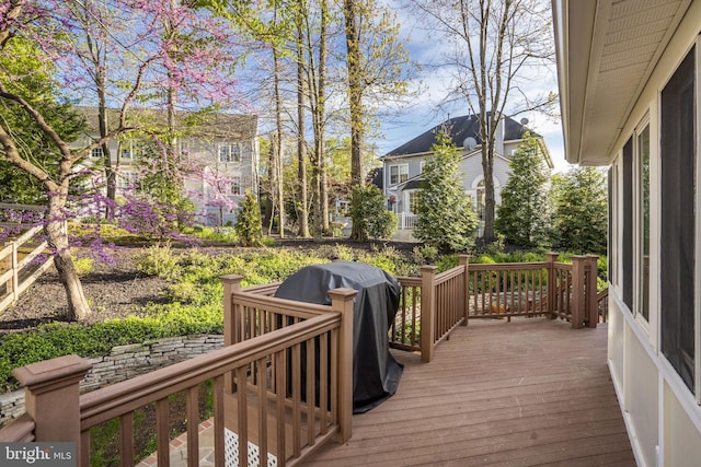 wooden terrace featuring a grill