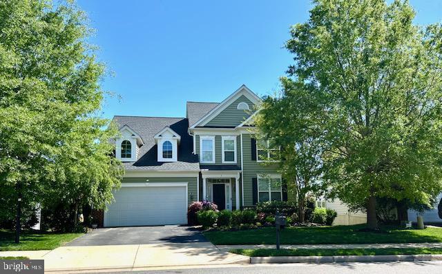 traditional home with driveway and a garage