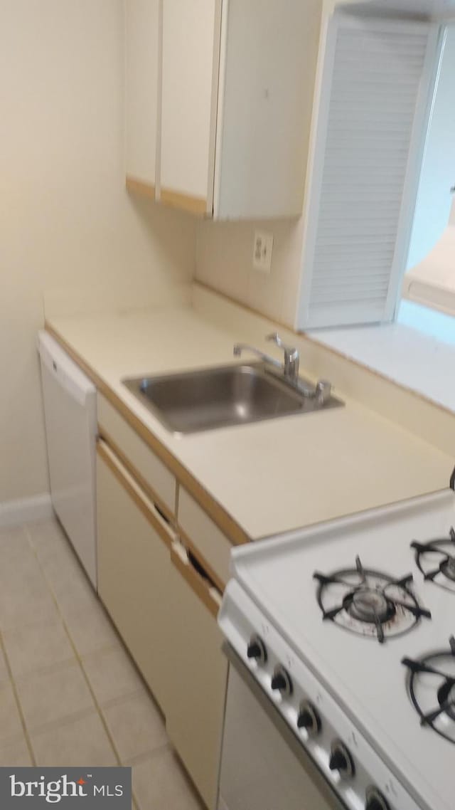 1021 Arlington Blvd Unit 928, Arlington, VA 22209 - kitchen with a sink, light tile patterned floors, white appliances, and light countertops