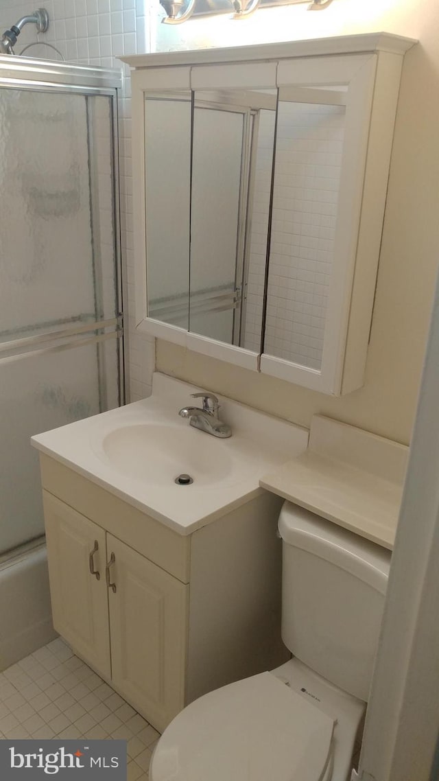 1021 Arlington Blvd Unit 928, Arlington, VA 22209 - full bath featuring toilet, tile patterned floors, bath / shower combo with glass door, and vanity