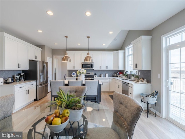 190 Petrelia Dr, Honey Brook, PA 19344 - kitchen with a sink, stainless steel appliances, white cabinetry, tasteful backsplash, and a kitchen island