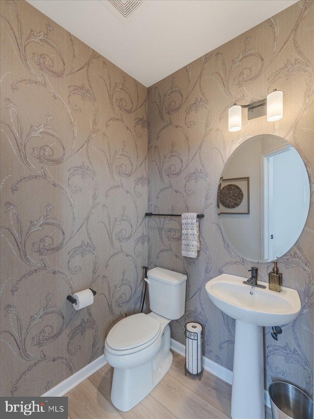 190 Petrelia Dr, Honey Brook, PA 19344 - half bath featuring visible vents, wood finished floors, toilet, and wallpapered walls