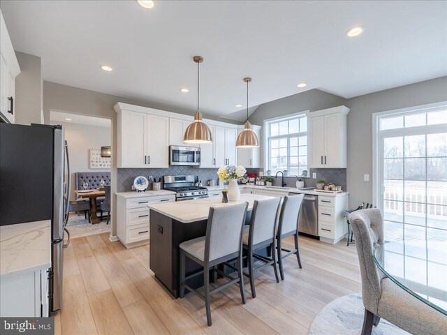 190 Petrelia Dr, Honey Brook, PA 19344 - kitchen with a center island, white cabinetry, tasteful backsplash, and stainless steel appliances