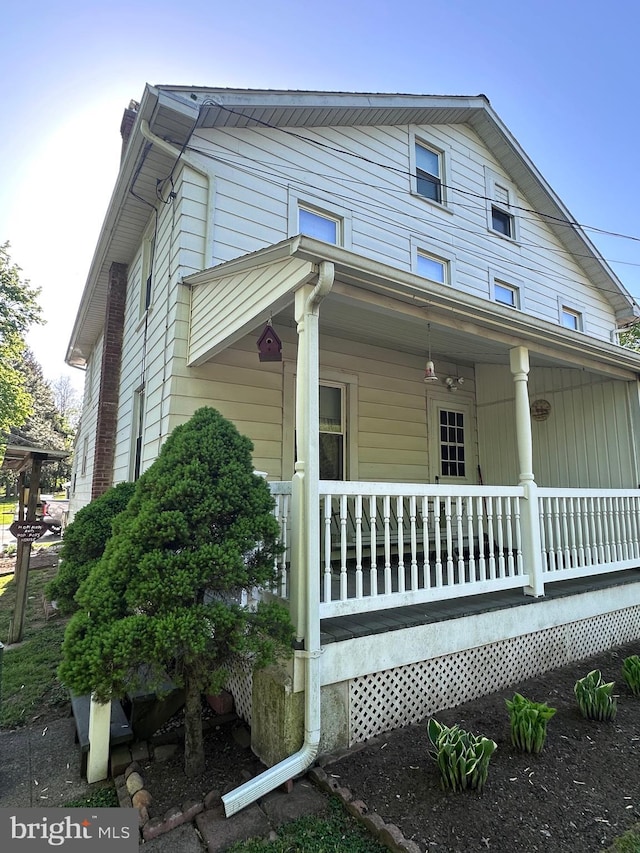 view of side of home with covered porch