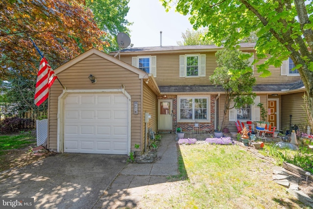 view of front of house featuring a garage, brick siding, and concrete driveway