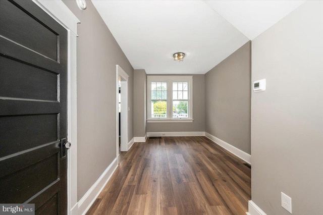 interior space with baseboards and wood finished floors