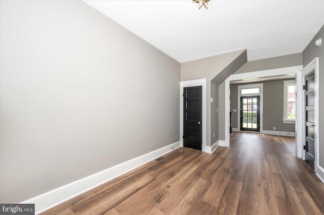 foyer with baseboards and wood finished floors
