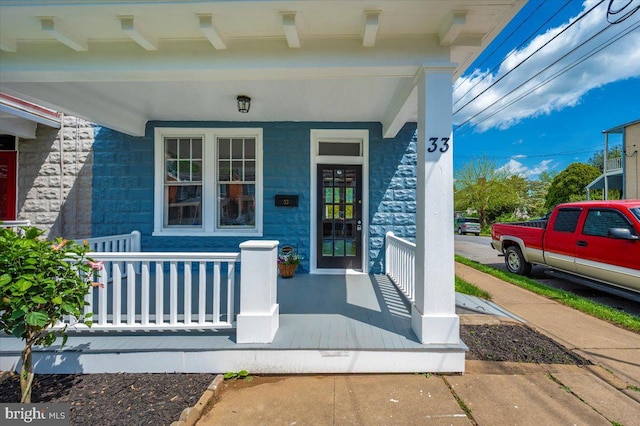 view of exterior entry with covered porch