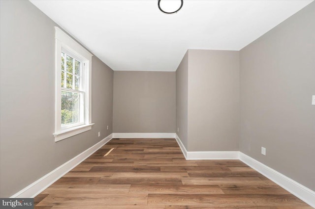 bonus room featuring baseboards and wood finished floors