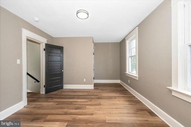 unfurnished room featuring baseboards and wood finished floors