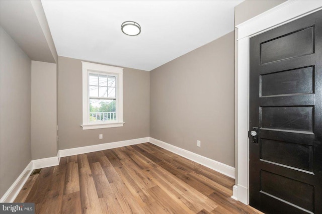 interior space with baseboards, visible vents, and wood finished floors