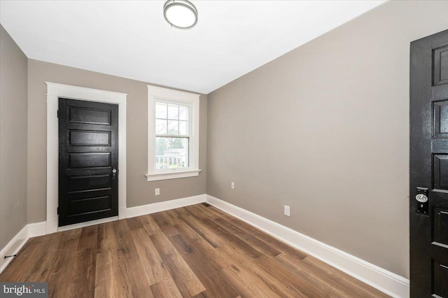 entrance foyer with baseboards and dark wood finished floors