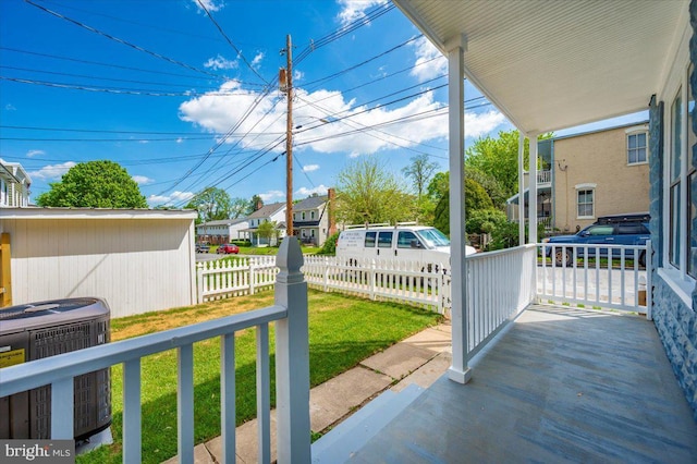 view of patio / terrace with a residential view, cooling unit, and fence private yard
