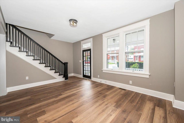 foyer with visible vents, baseboards, stairs, and wood finished floors