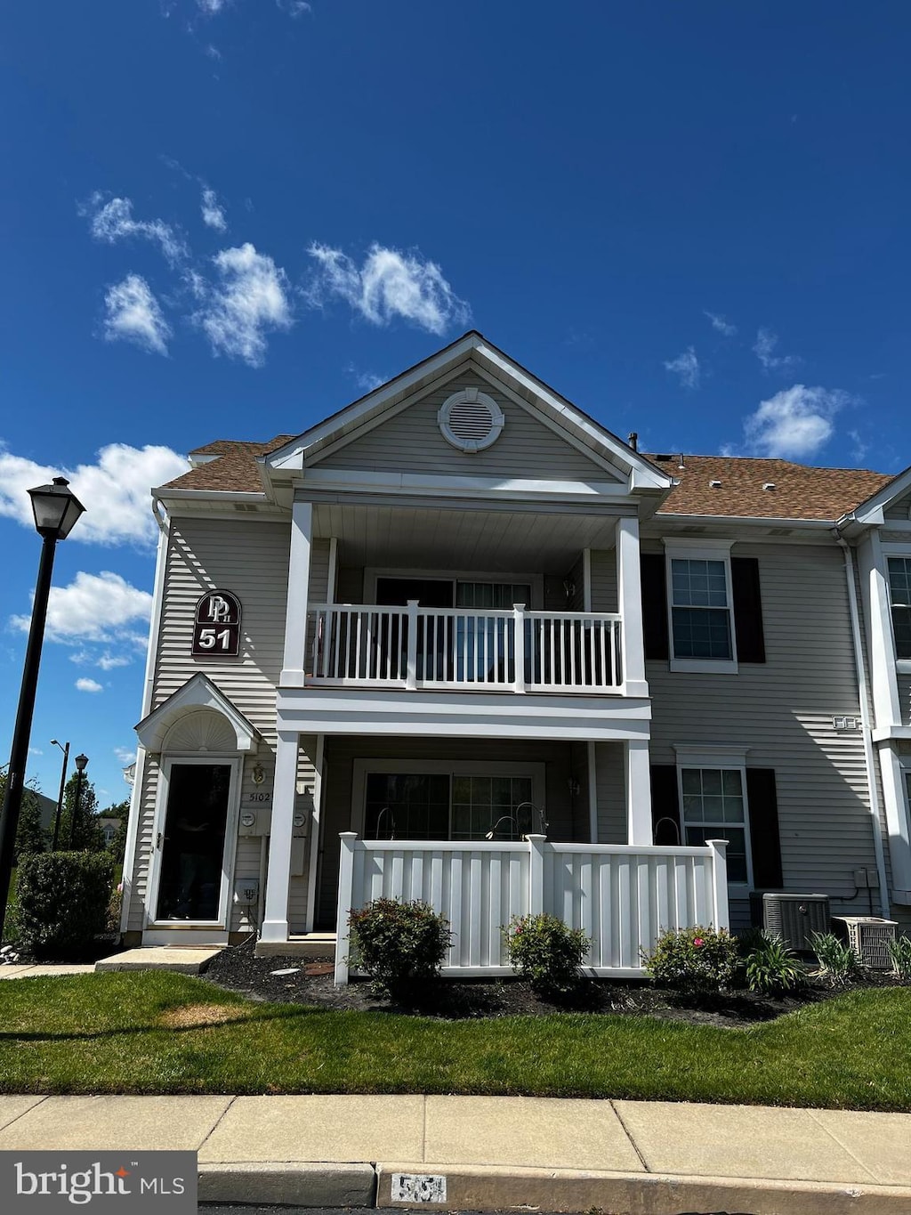 view of front facade featuring cooling unit and a balcony
