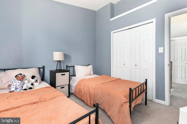 bedroom featuring light carpet and a closet