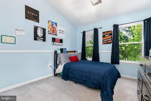 bedroom with carpet, visible vents, and multiple windows