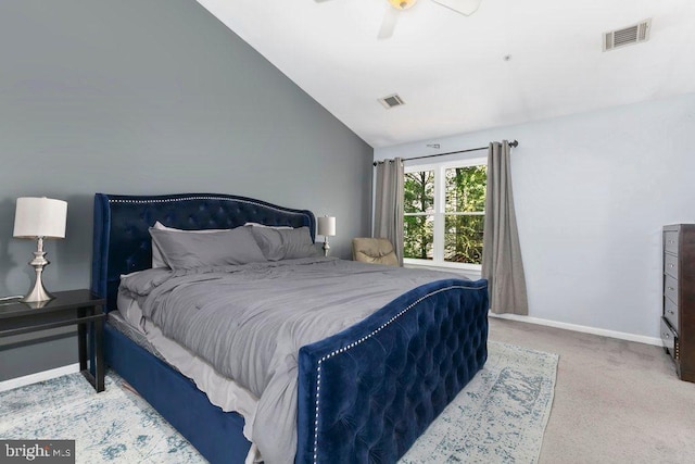 carpeted bedroom with baseboards, visible vents, and vaulted ceiling