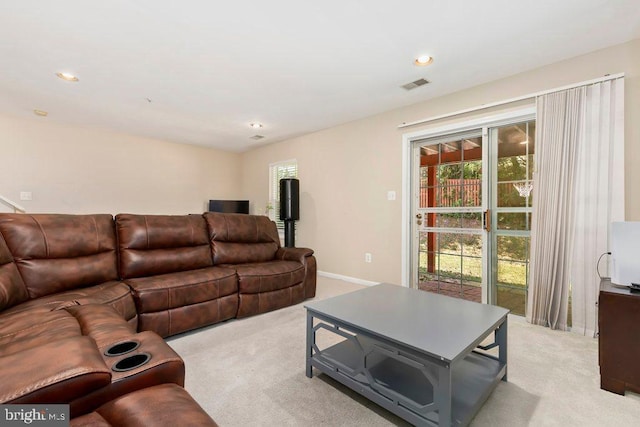 carpeted living area featuring visible vents, baseboards, and recessed lighting